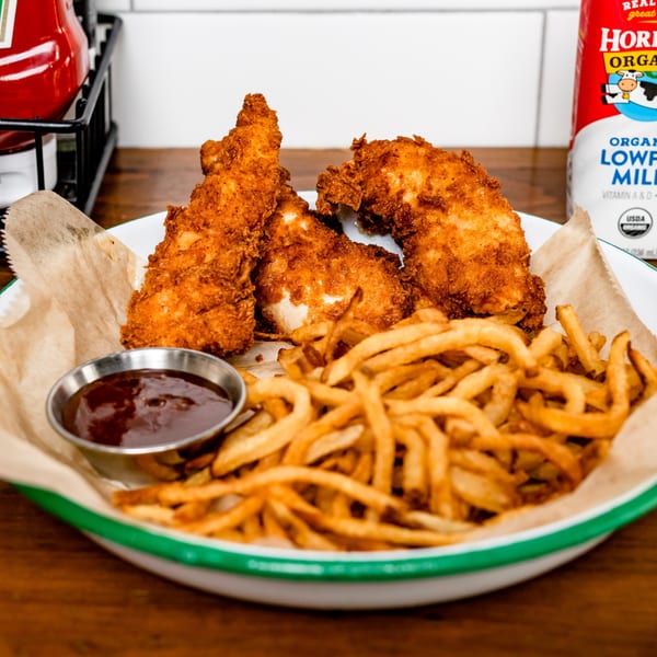 BuffBurger's crispy chicken tenders and golden french fries with a side of BBQ sauce.